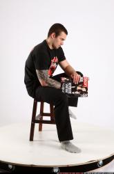 Alex Sitting With Pistol Pose